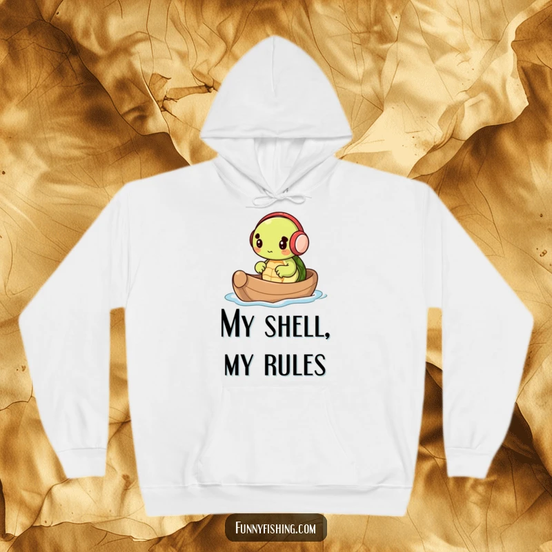 Soft hoodie showcasing a tiny turtle in earmuffs, rowing a nutshell boat with determination and joy, a funny and comforting piece.